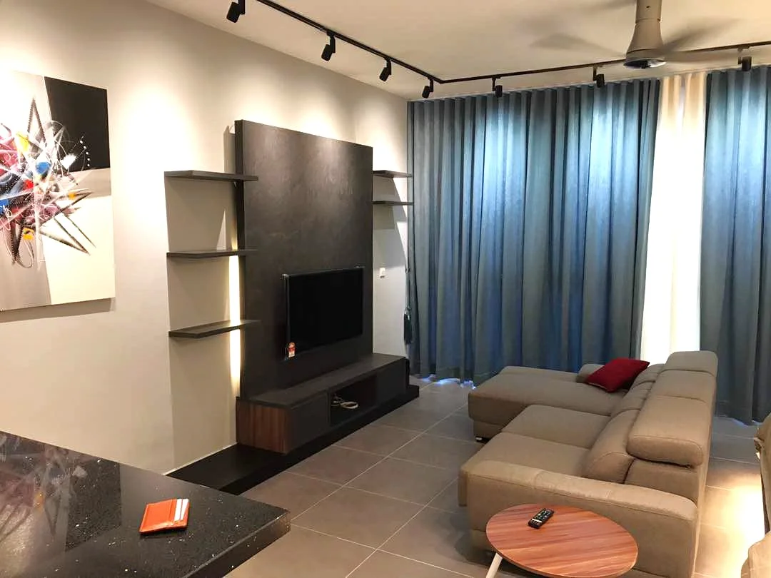 Living features: grey fabric L-shape sectional sofa, round wooden coffee table, wall-mounted TV, black feature wall, open shelving units, grey tiled flooring, recessed LED downlights, 5-blade ceiling fan, floor-to-ceiling curtains in blue and cream, framed artwork on wall; style: modern.